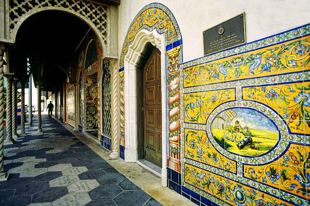 A colorful yellow, blue, and floral mural in a historic alleyway in Ybor City, one of the best cheap things to do in Tampa Bay