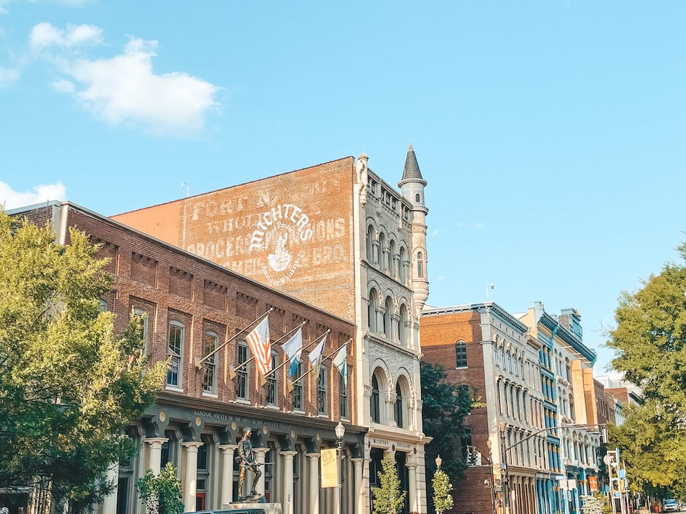 The exterior of Mitcher's Bourbon Distillery and other historic buildings in Downtown Louisville, one of the best day trips from Nashville.