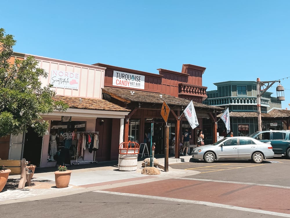 The rustic, old-timey western facade of the 5th Avenue Shops, one of the best places to go shopping in Scottsdale.