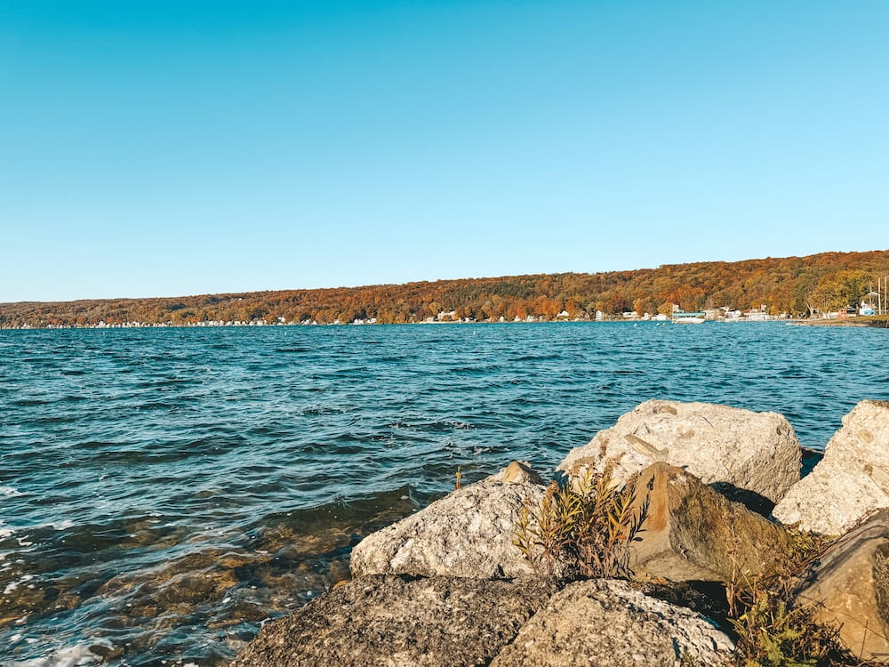 A gorgeous view of Keuka Lake surrounded by lush fall foliage.