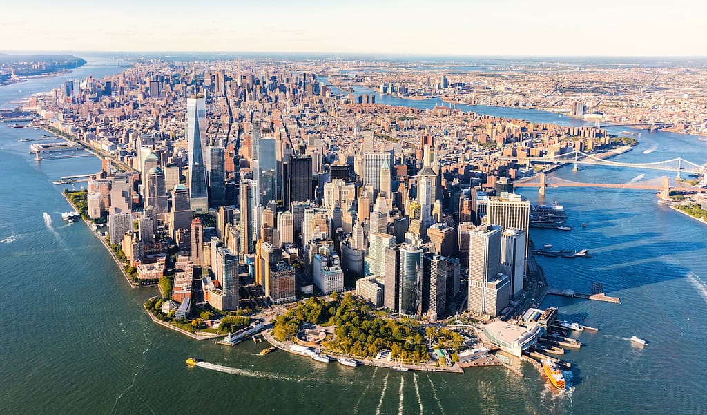 An aerial view of New York City, including the Brooklyn Bridge and Lower Manhattan