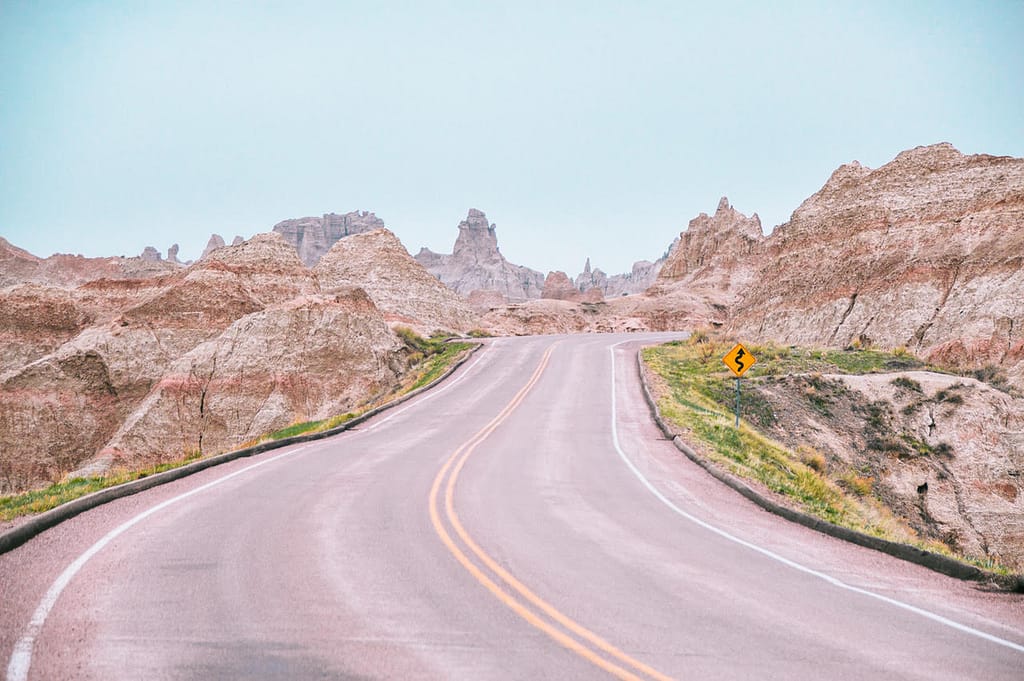 A road winding through the canyons at Badlands National Park.