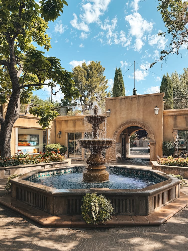 A beautiful fountain surrounded by greenery in Tlaquepaque in Sedona
