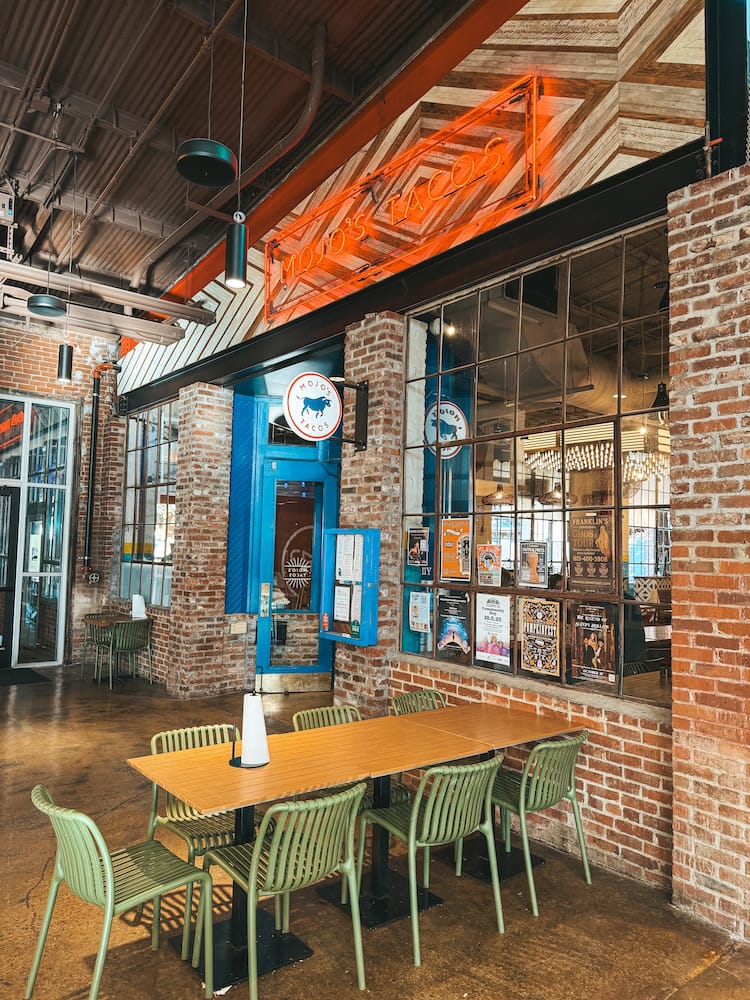 The red-brick exterior of Mojo's Tacos inside The Factory at Franklin