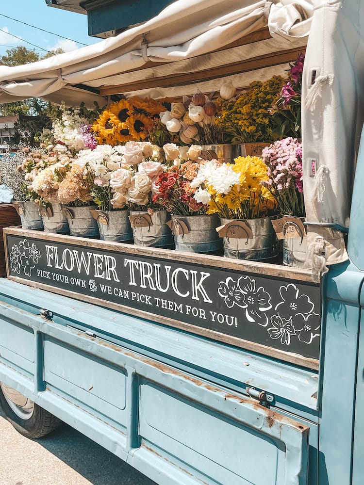A close-up photo of the metal buckets of flowers inside of a Flower Truck for "create your own bouquets" from Amelia's Flower Truck in 12 South