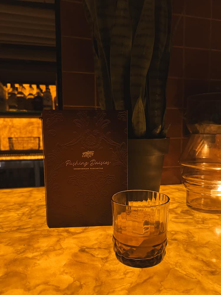 A cocktail sitting on the bar at Pushing Daisies, an underground margarita bar on Broadway Street in Nashville