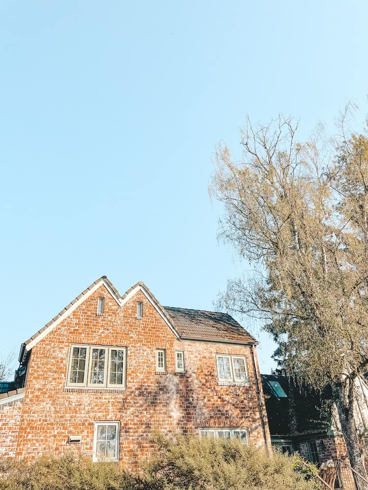 A house made from red brick against a blue sky.