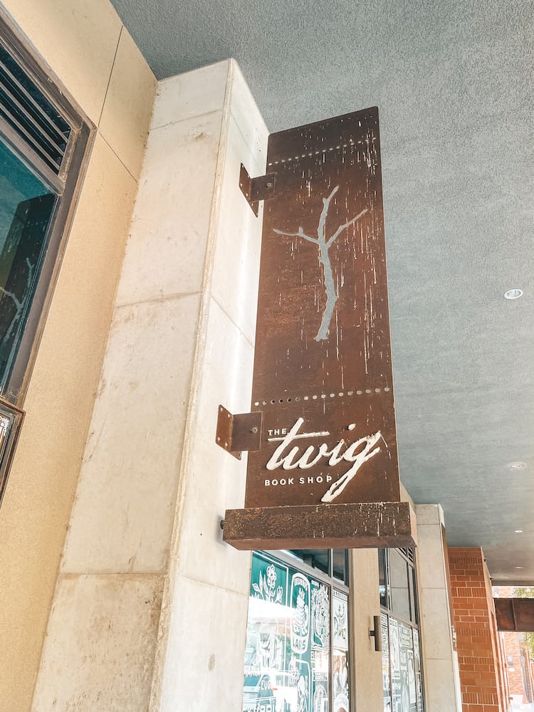 The brown metal sign for The Twin Book Shop at the Pearl in San Antonio
