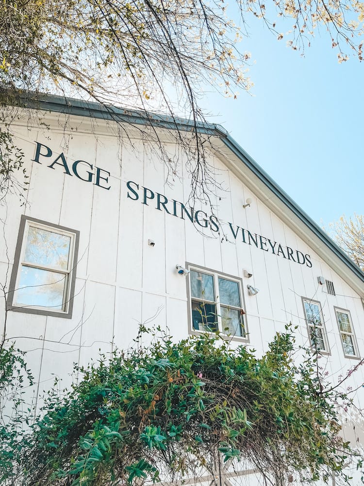 The exterior of Page Springs Vineyards, a winery in Sedona located inside a renovated white barn.