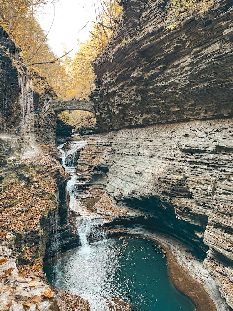 An iconic bridge and waterfall on the Watkins Glen Gorge Trail in Watkins Glen State Park