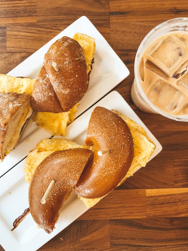 A bagel sandwich, croissant sandwich, and iced coffee from The Frothy Monkey, one of the best spots for brunch in Nashville