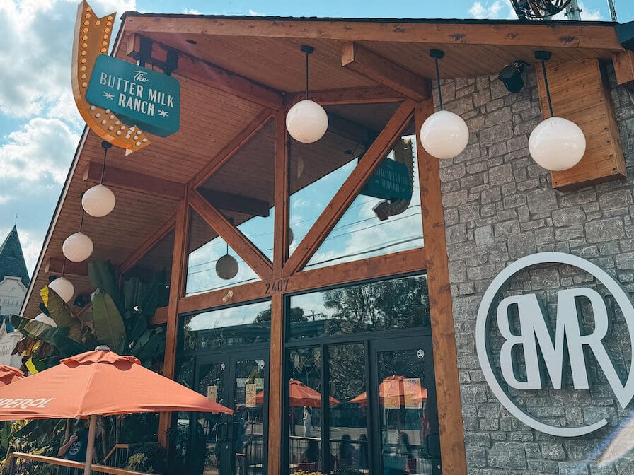 The brick and wood lodge-style exterior of The Butter Milk Ranch in 12 South