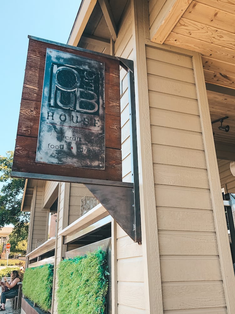 A wood and metal sign for a gastropub at a brunch spot in Old Temecula.