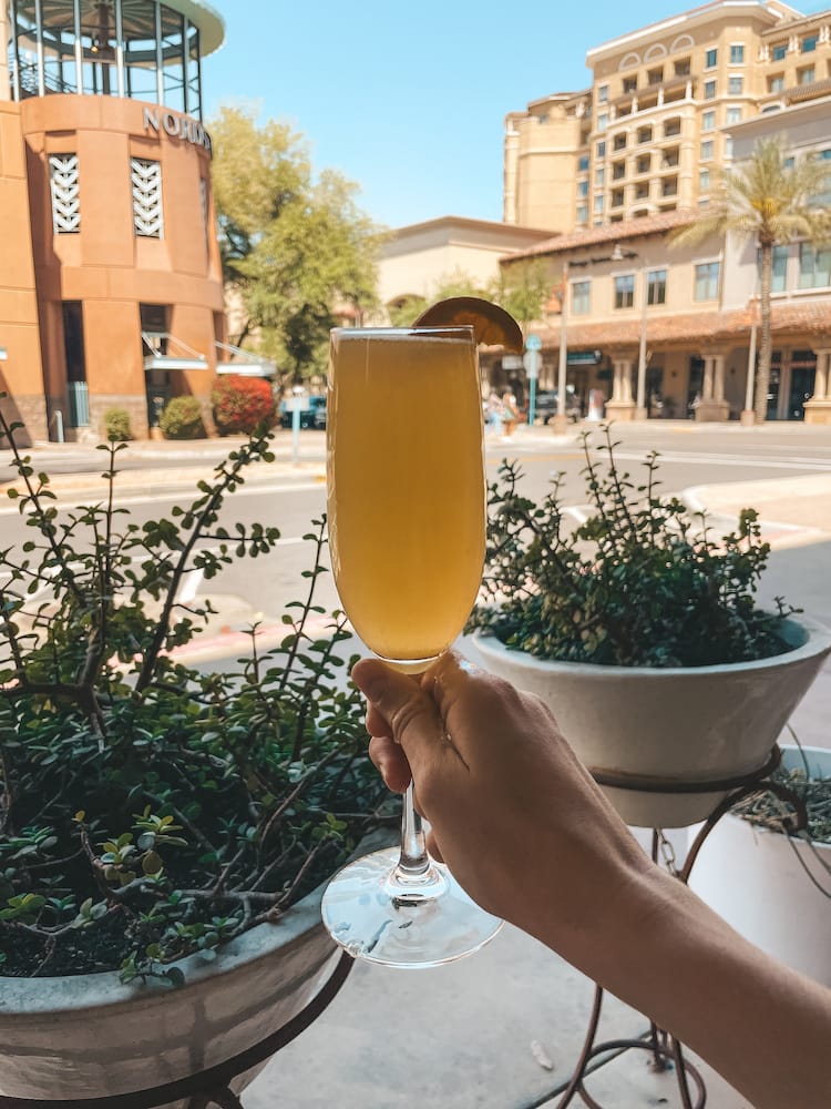 An orange mimosa in front of the Southwestern-style shops in Old Town Scottsdale from Prep and Pastry