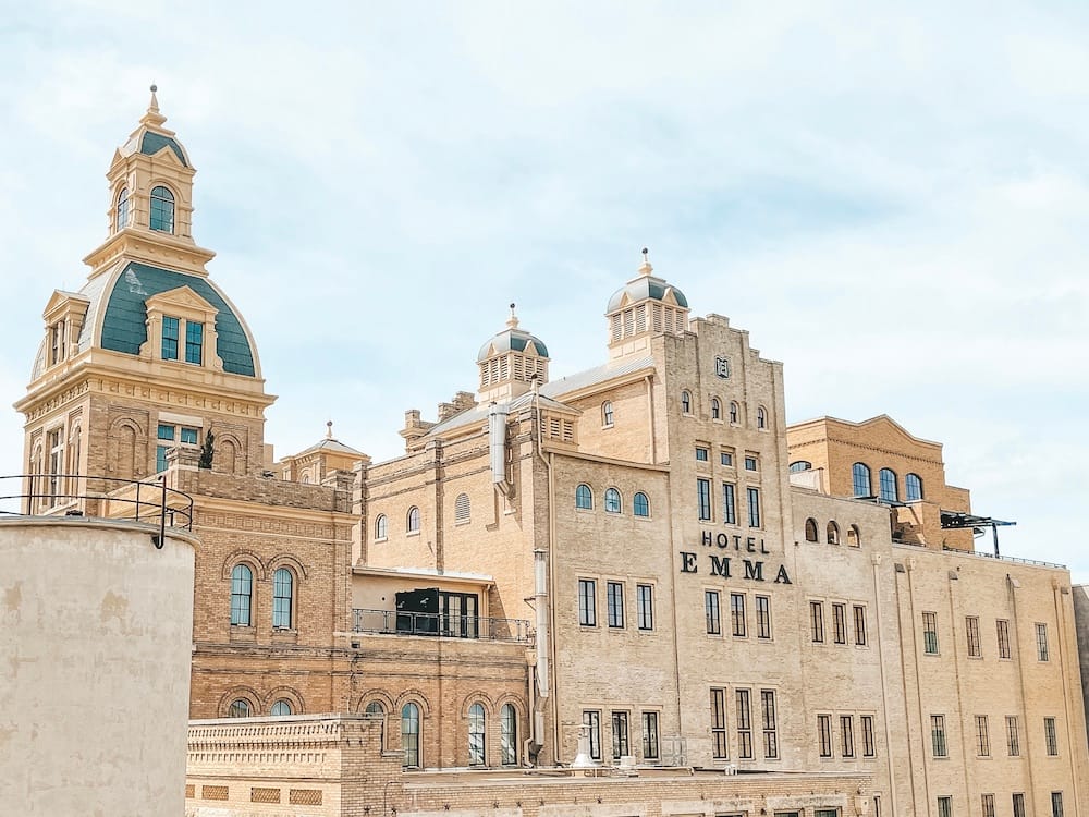 The tan brick exterior of Hotel Emma, the stunning historic hotel at The Pearl in San Antonio