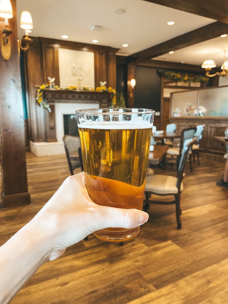 A beer being held up in a old-world looking brewery in Fredericksburg, TX