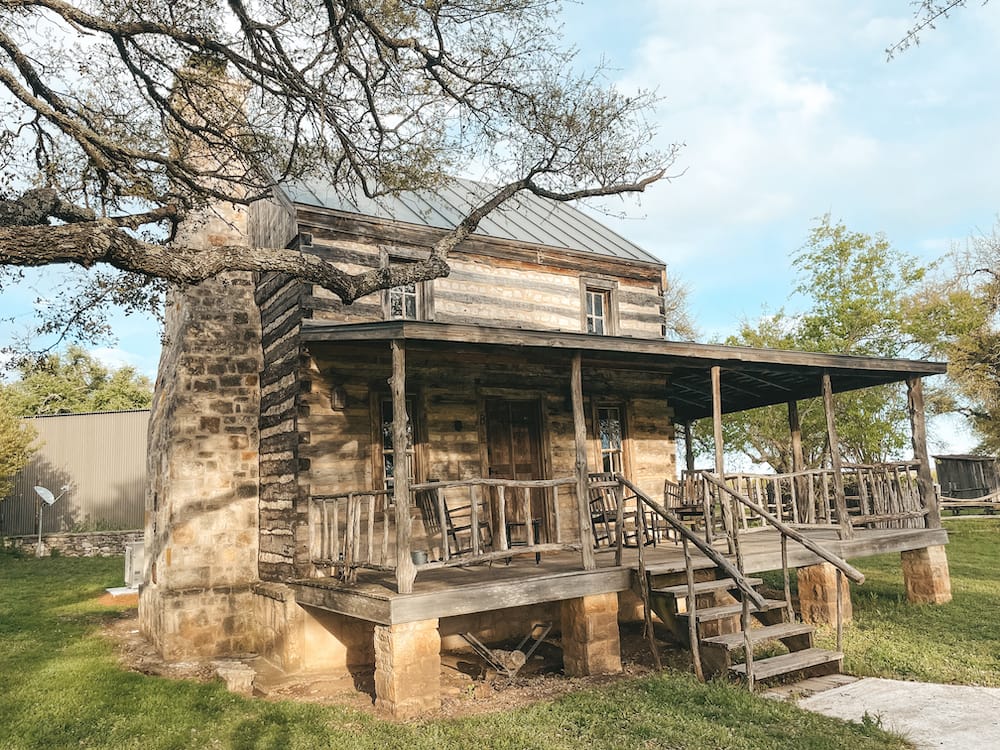 A 1800s-style Kentucky log cabin in the Texas Hill Country at Contigo Ranch.