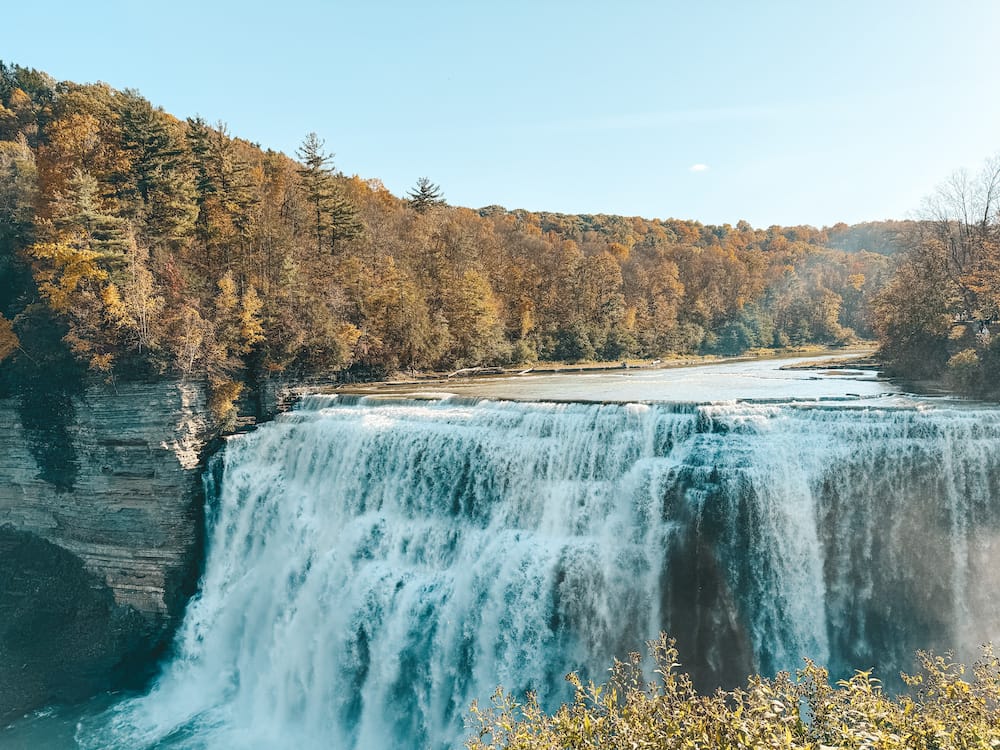 Middle Falls in Letchworth State Park surrounded by yellow and orange fall trees.
