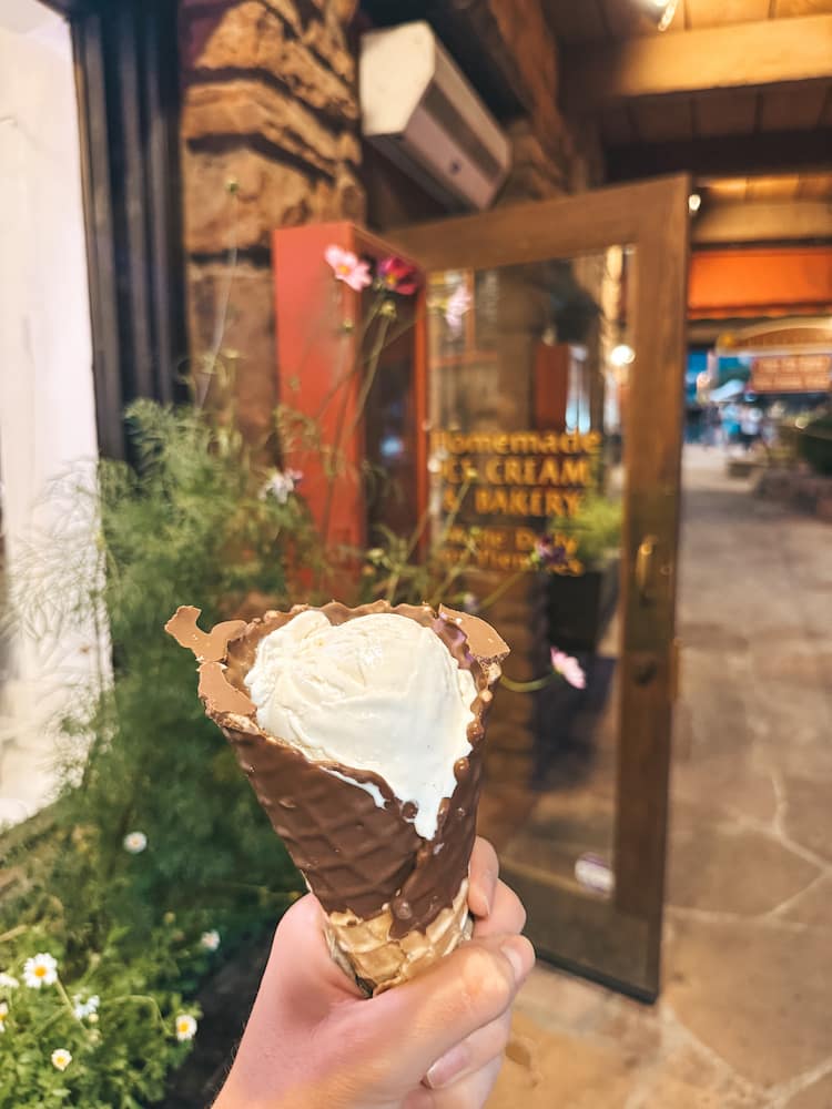 An ice cream cone in front of the entrance of Black Cow Cafe, one of the best spots to stop for dessert in Sedona
