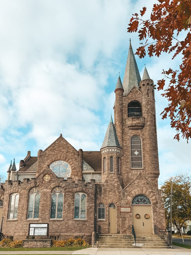 A historic church in Downtown Penn Yan - a town where to stay in the Finger Lakes - in front of a cloudy blue sky
