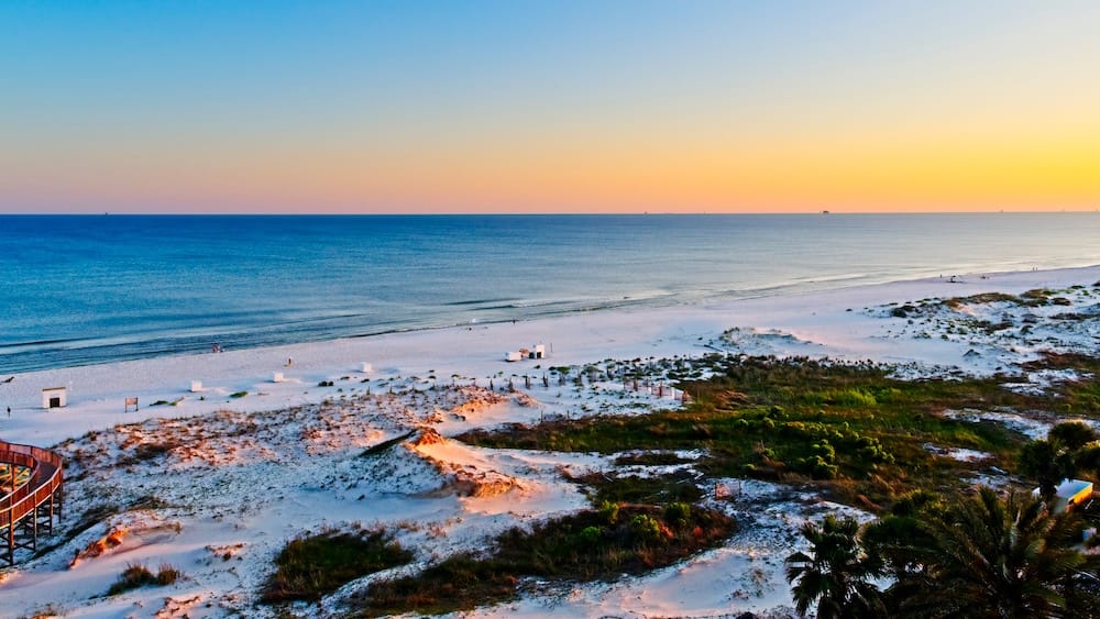 A white-sand beach in Gulf Shores, Alabama - one of the best places to visit in May in the USA.