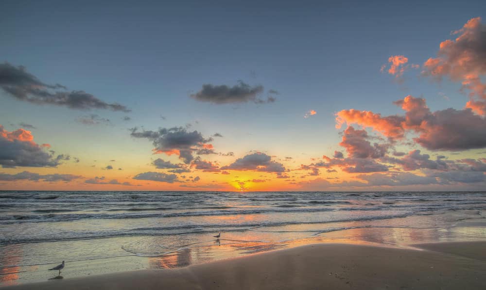 A sunset on the beach in South Padre Island Texas, one of the best places to visit in February in the USA