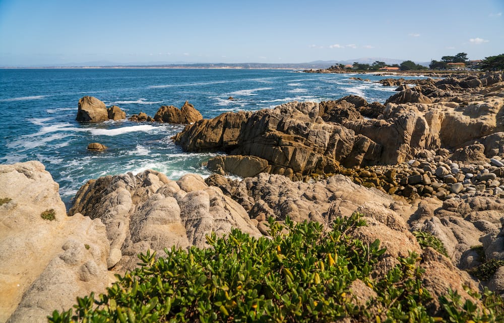 A view of the rocky coastline overlooking the ocean at Lovers Point in Monterey, California.