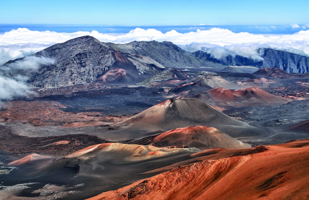 The red mountains sitting under the clouds at Haleakala National Park on Maui.