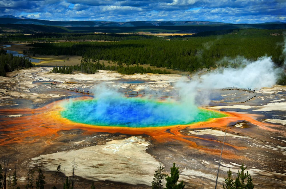 The colorful Grand Prismatic Springs with rainbow colors and steam in Yellowstone National Park.