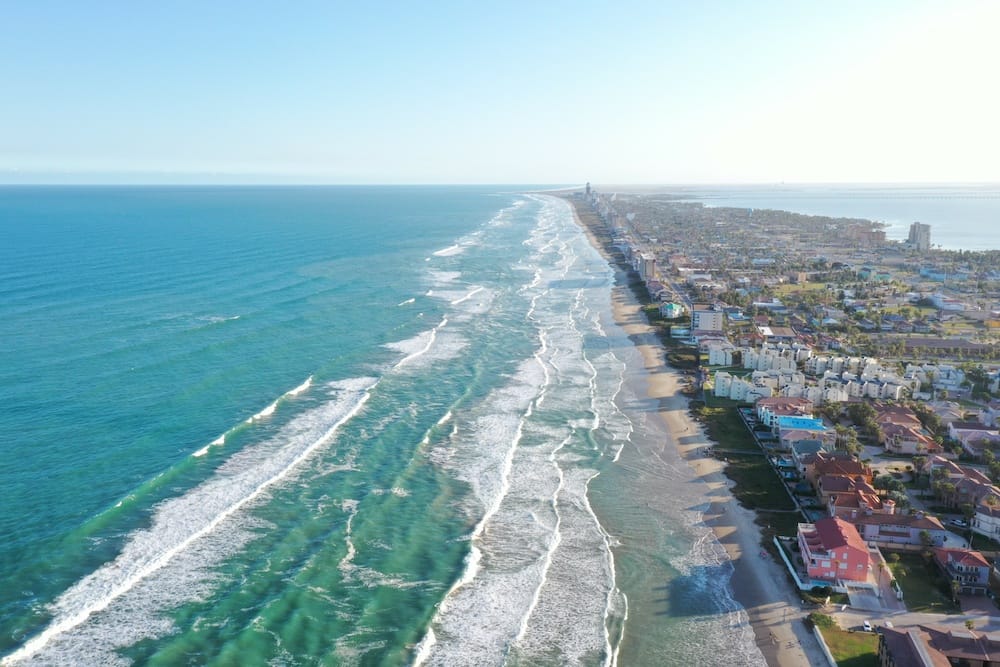 An aerial view of the blue-green ocean and city at South Padre Island in Texas.