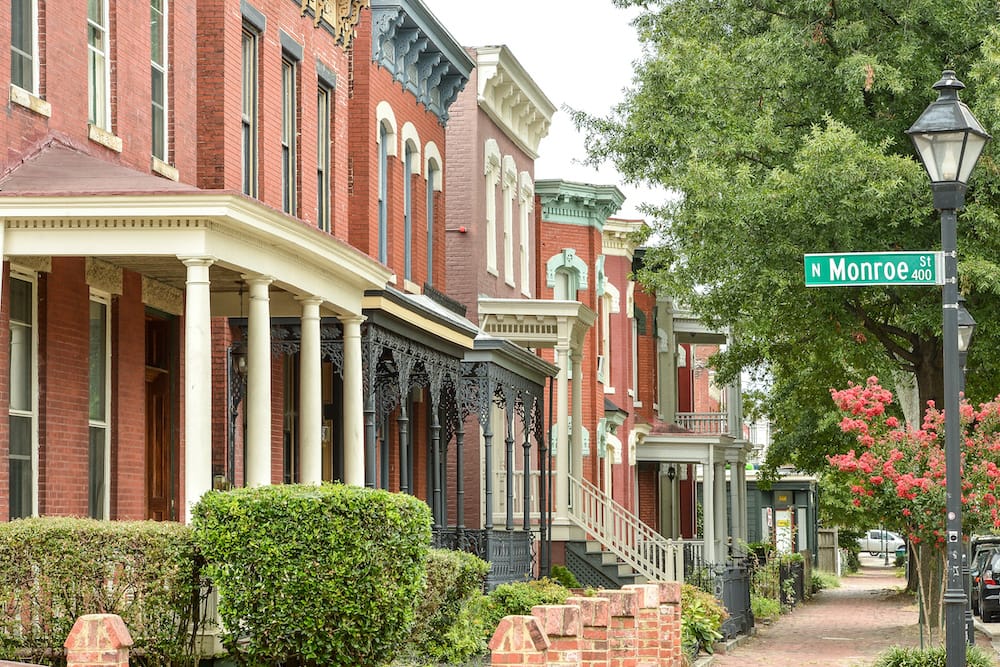 Red brick buildings, greenery, and a cobblestone pathway in Richmond, Virginia.