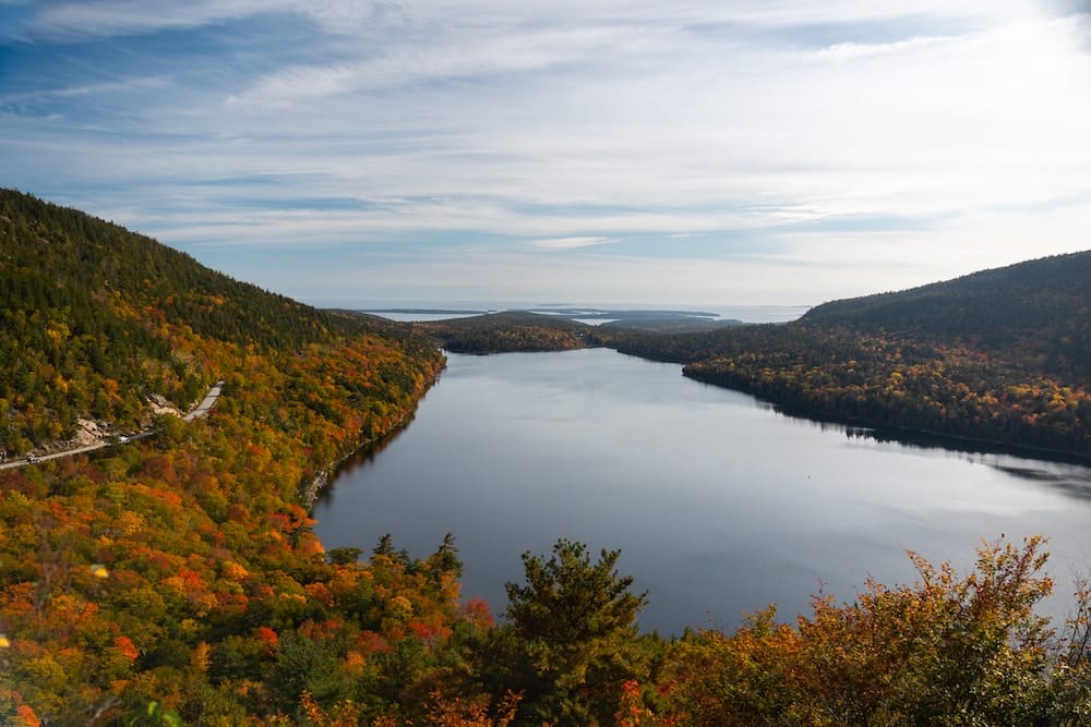 An aerial view of the fall foliage and lake in Acadia National Park in October.