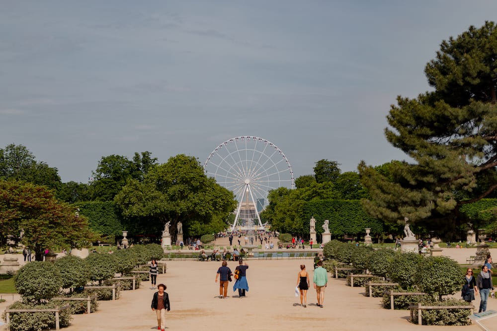 A Ferris wheel in a lush, green garden, one of the best things to do during a weekend in Paris.