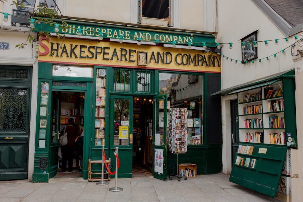 Shakespeare and Company Bookstore in Paris, with a green exterior and yellow sign.