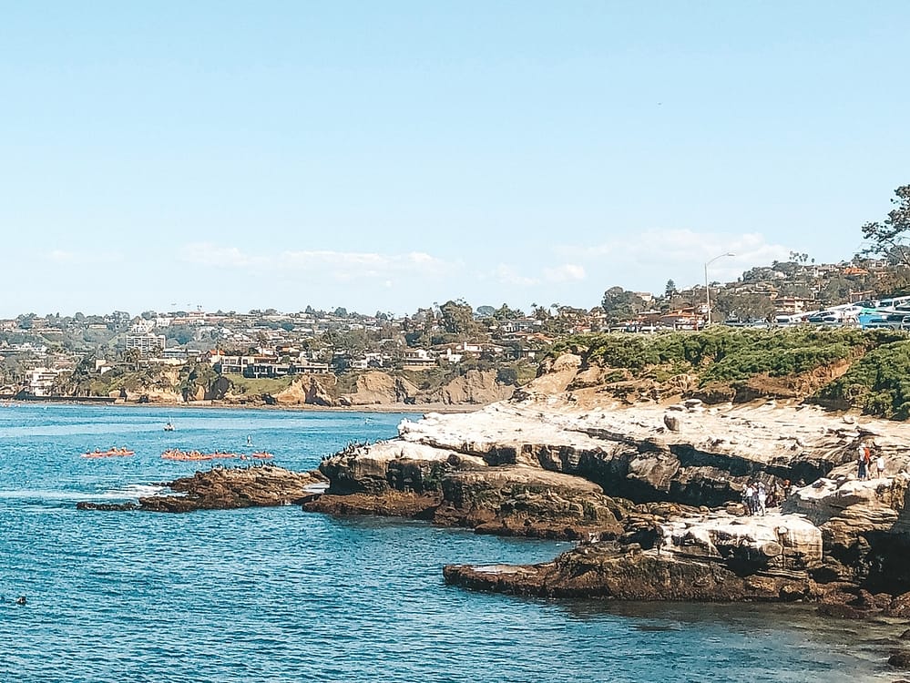A view of La Jolla Cove and the rocky coastline in La Jolla, one of the best places to visit in February in the USA.