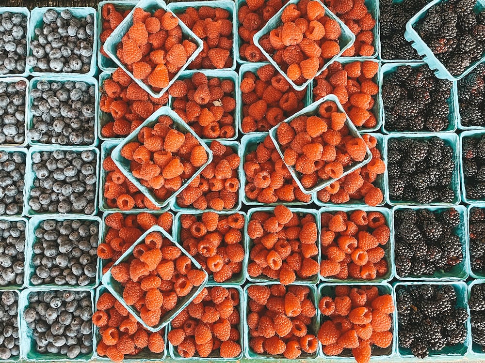Fresh raspberries, blackberries, and blueberries at Pike Place Market in Seattle.