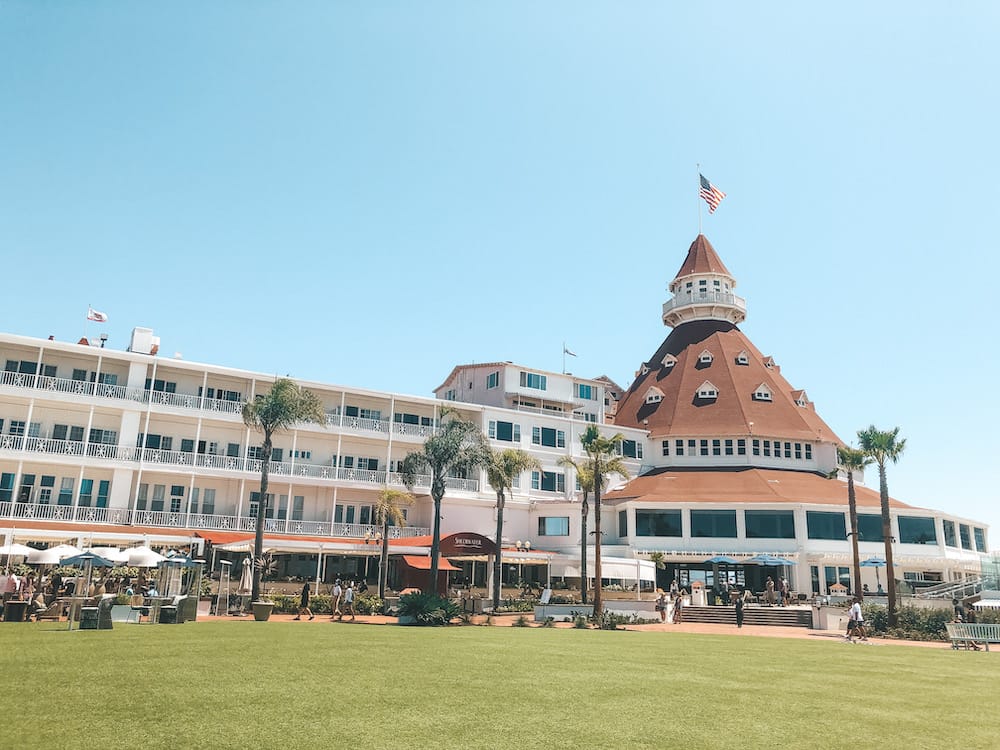 The Hotel del Coronado with a burnt orange roof and white exterior on Coronado Island in San Diego.