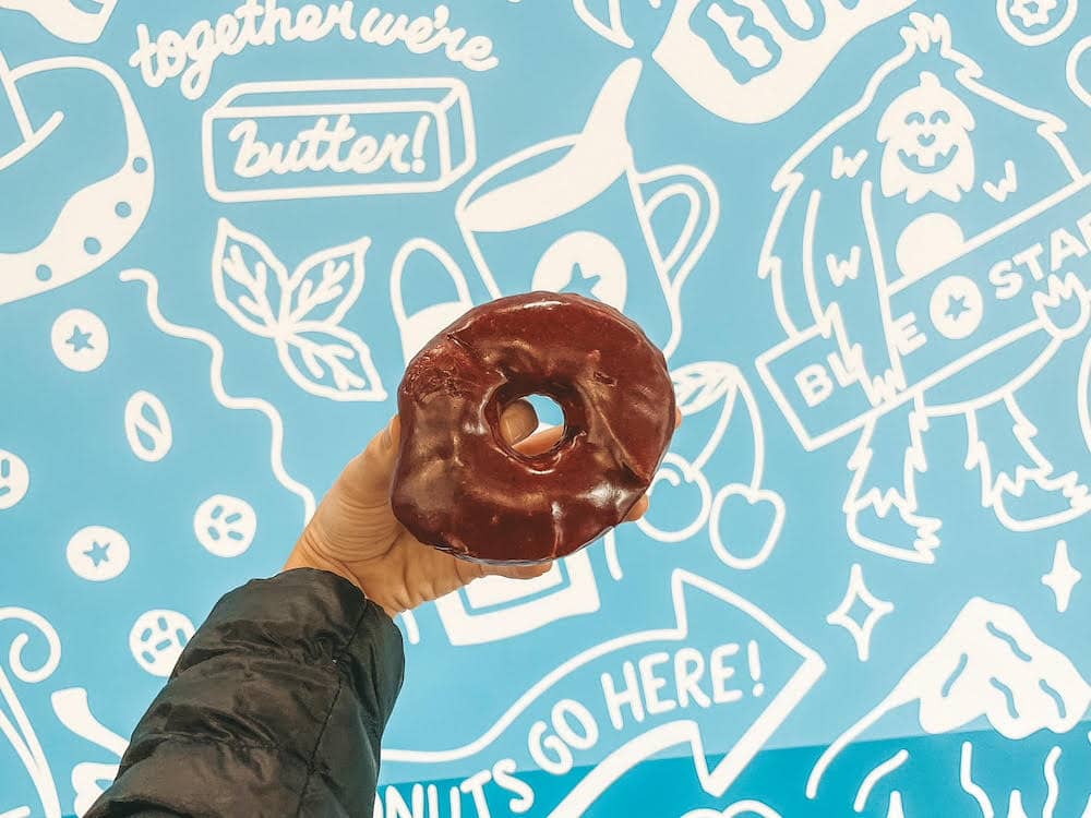 A donut on front of a blue wall at Blue Star Donuts in Portland, Oregon