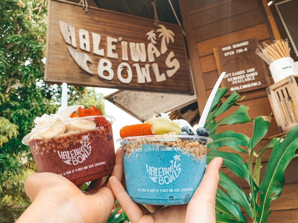 Two colorful blue and purple acai bowls on the North Shore Hawaii from Haleiwa Bowls.