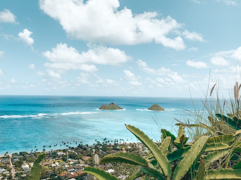 The blue island water and greenery from the top of the Lanikai Pillbox Hike in Oahu, Hawaii