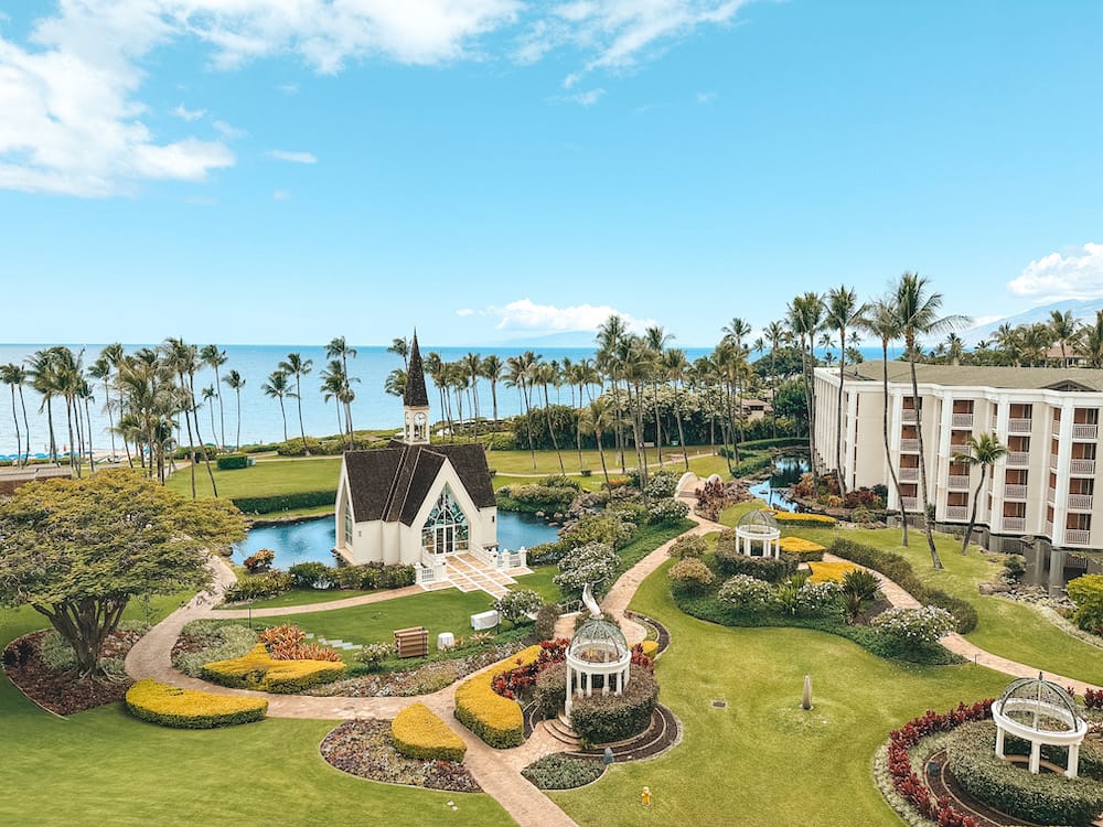 A lush garden surrounding a charming wedding chapel overlooking the beach at one of the best luxury resorts in Maui, Hawaii.