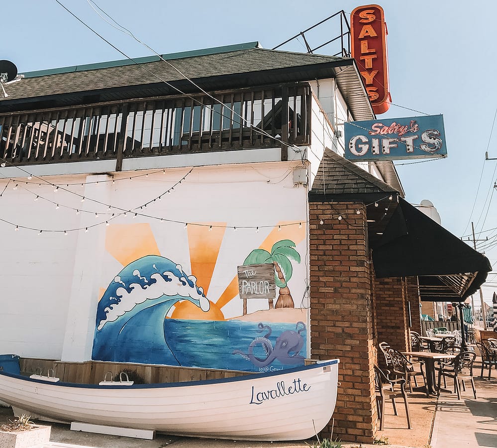 The side of a building with a beach mural and small boat in Lavallette, New Jersey