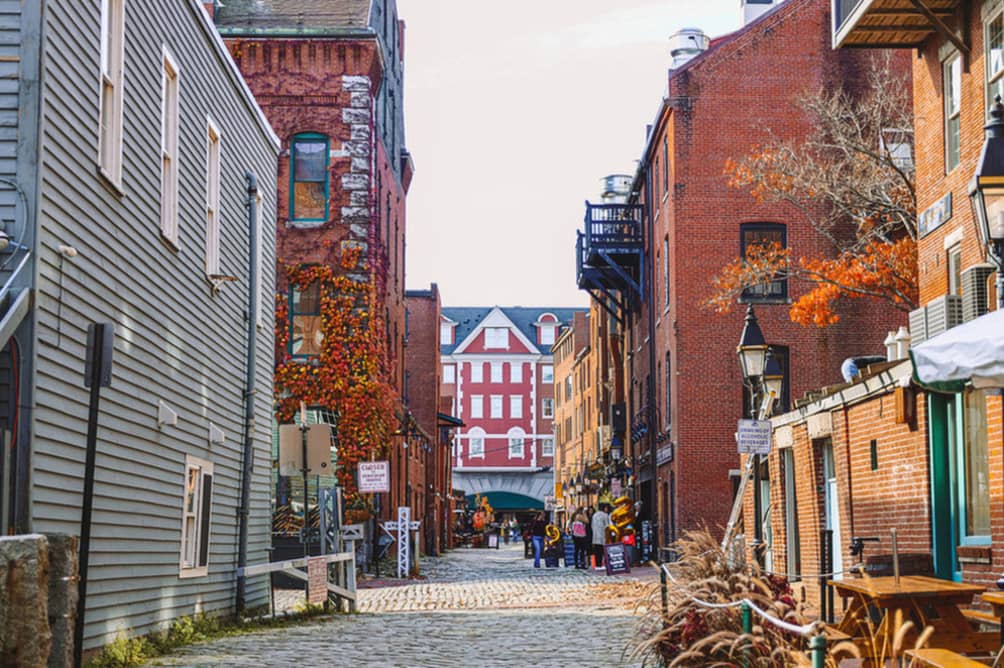 Red brick buildings and cobblestone alleyways in Portland, Maine - one of the best places to visit in May in the USA