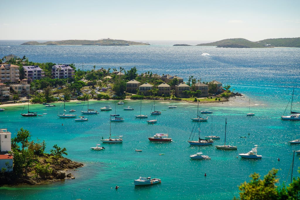 An aerial view of a cove with dozens of sailboats in the U.S. Virgin Islands