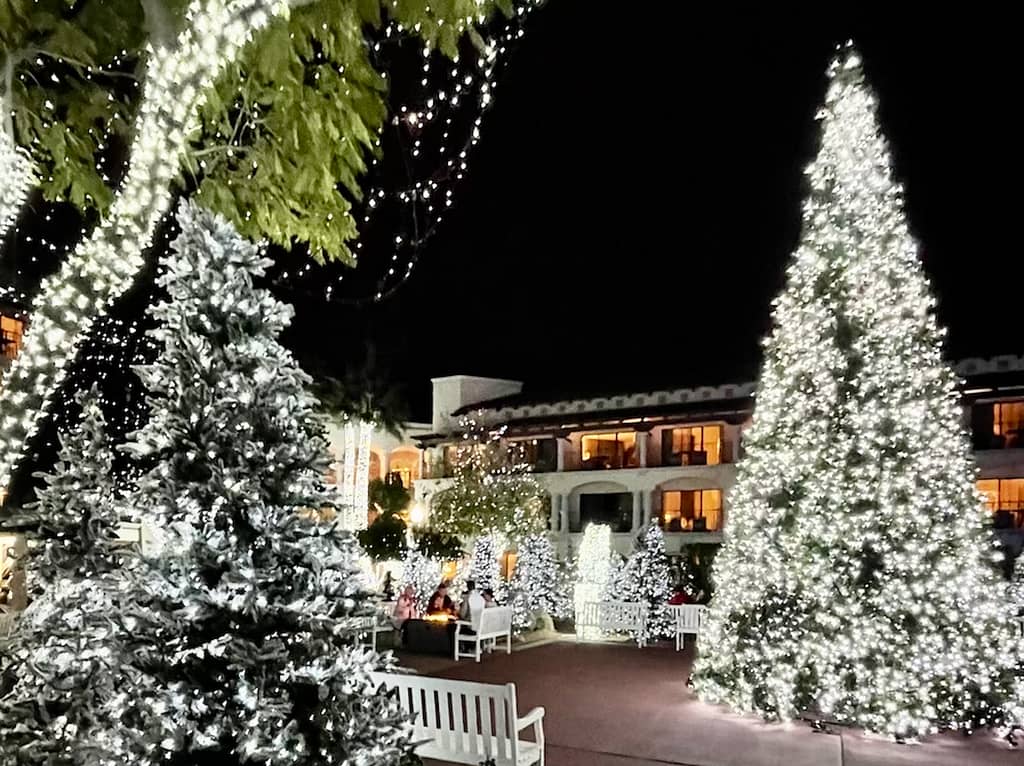 The white trees at the Fairmont Scottsdale Princess – one of the best places to visit in the USA in December - illuminated for the holiday season.