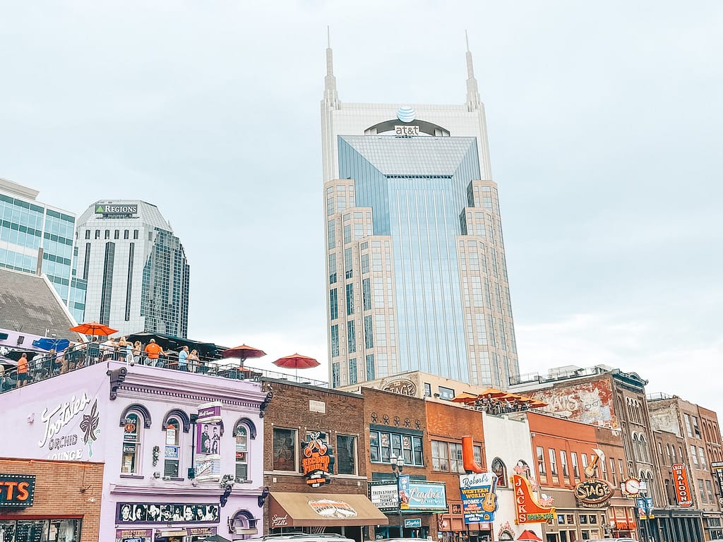 A view of the skyline on Broadway Street in Nashville, Tennessee, featuring the AT&T building and other popular buildings, like Tootsie's Orchid Lounge, The Stage, and Robert's Western World.