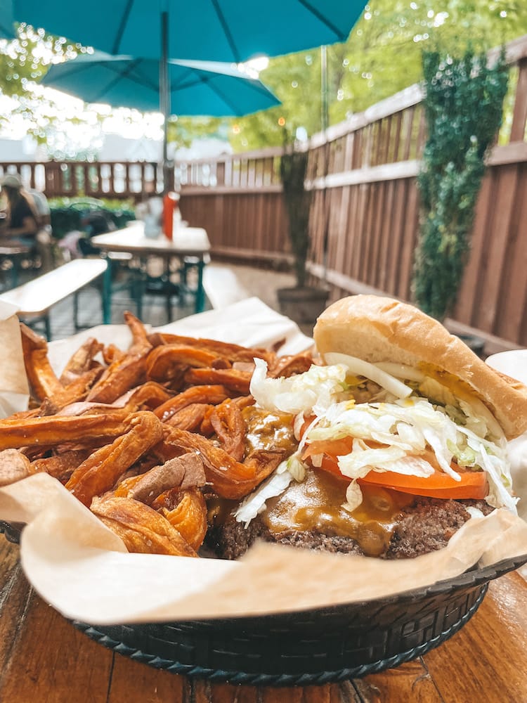 A basket with a burger and sweet potato fries at Pharmacy Burger, a beer garden in Nashville