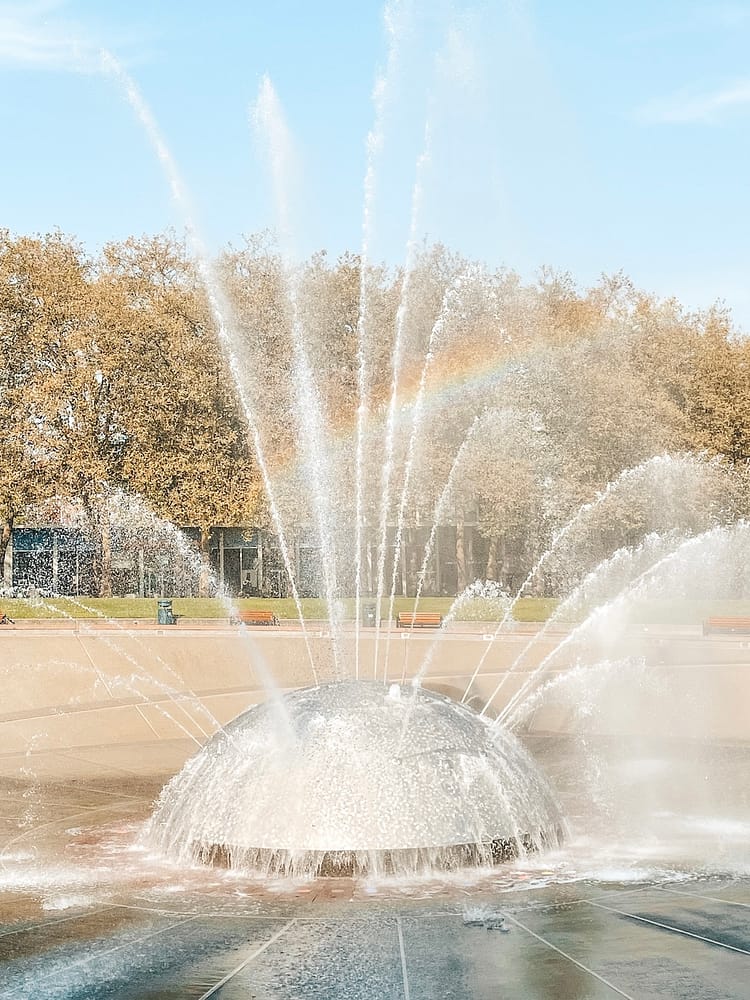 The International Fountain in Seattle with a rainbow in the water shooting up