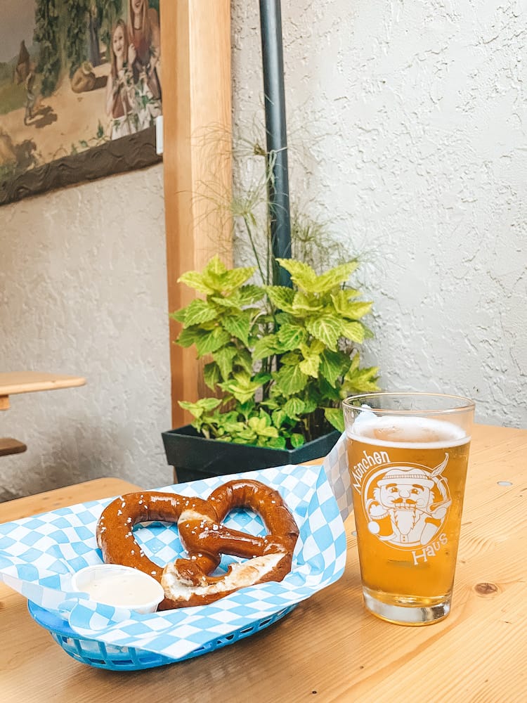 A pretzel and beer in an outdoor bier garden.