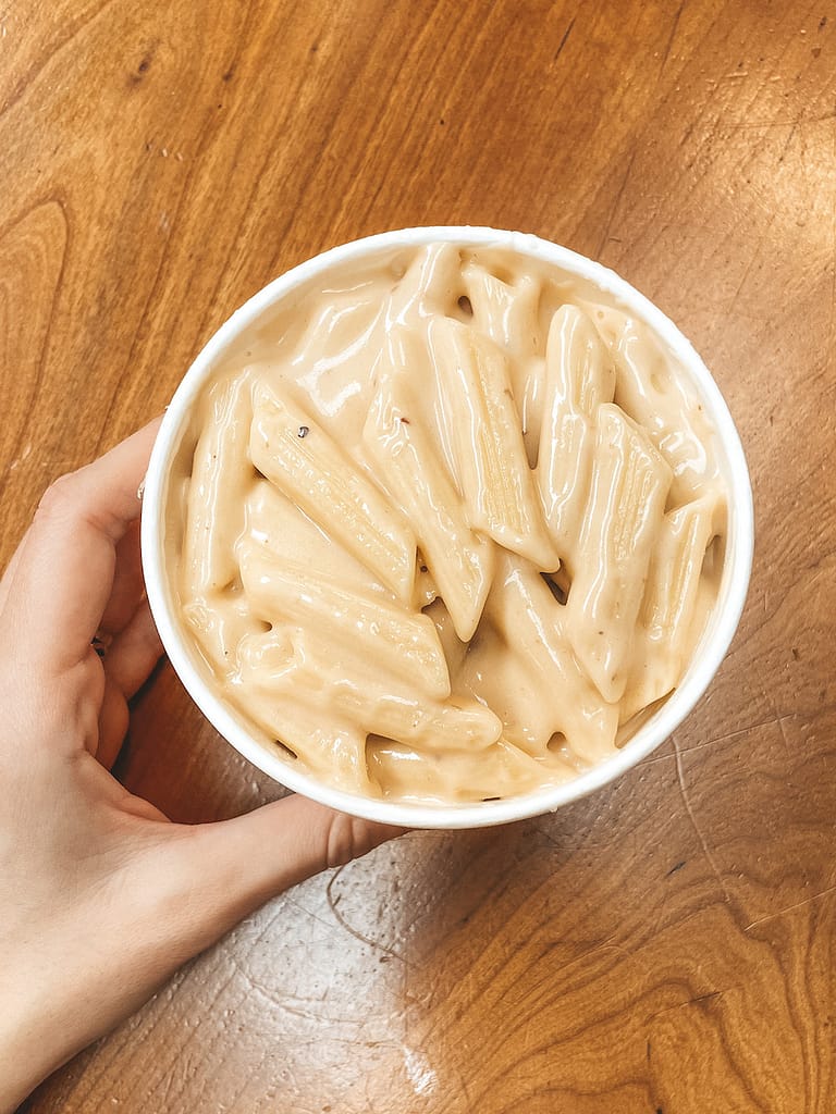 Beecher's Mac and Cheese sitting on a wooden table from Pike Place Market in Seattle